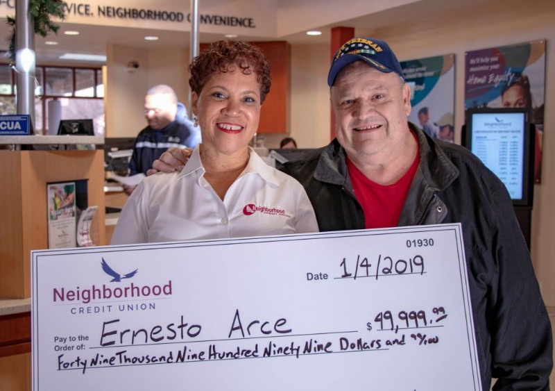 Man and woman holding large check