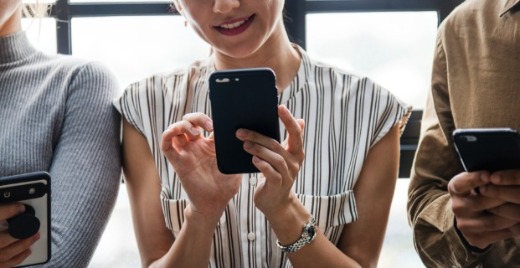 A group of people using mobile phones