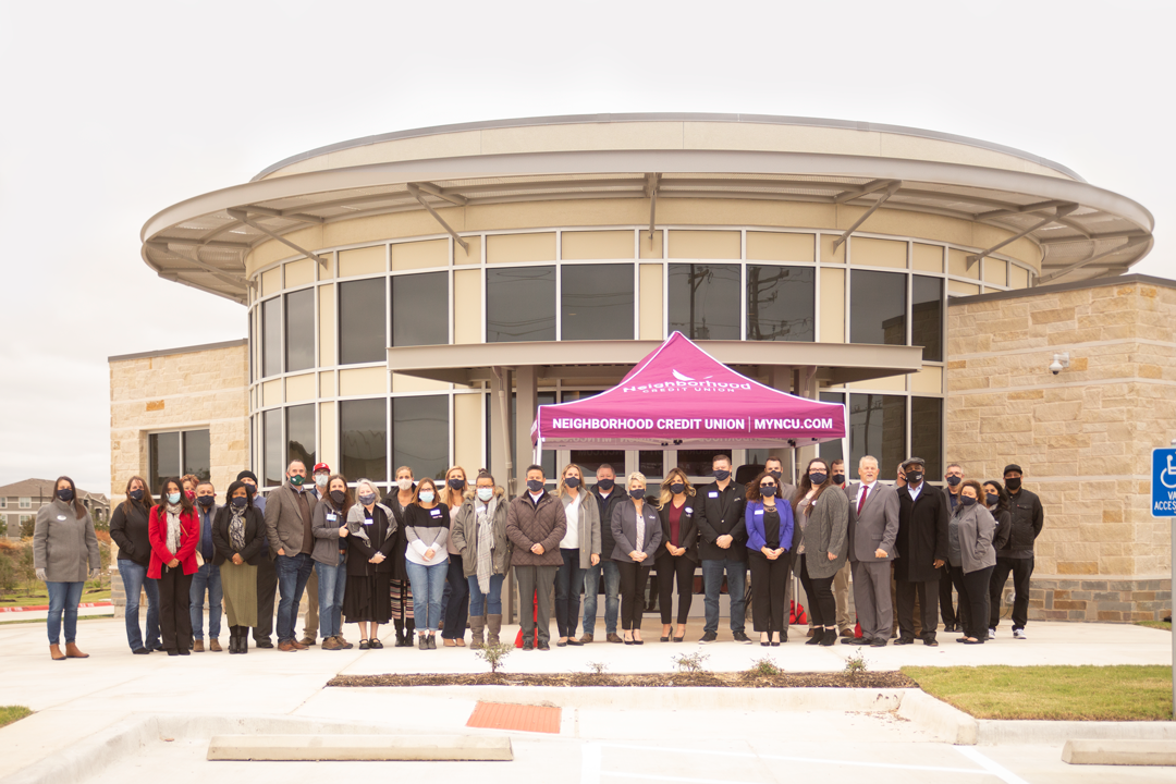 several people standing in front of round building