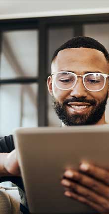 man smiling down at iPad 