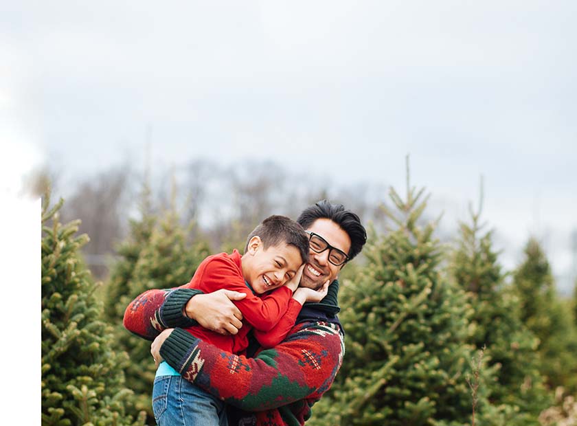 Father and son hugging and smiling