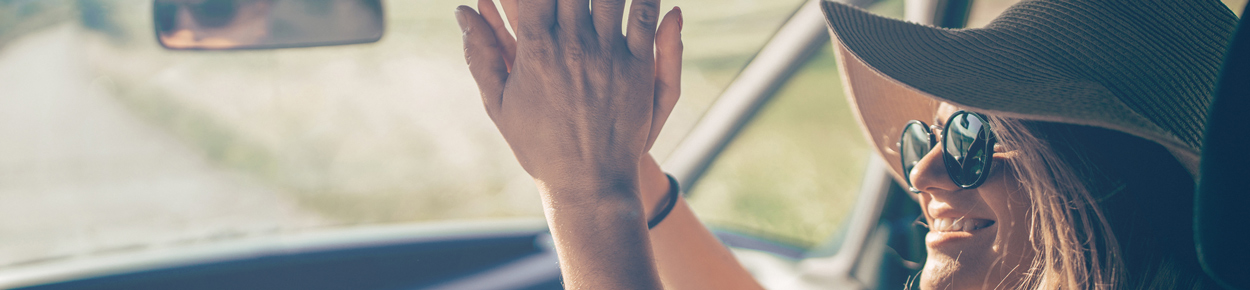 Woman sitting in the front seat high-fiving driver.