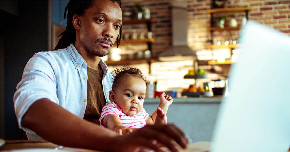Close up of father and daughter having breakfast and looking at computer