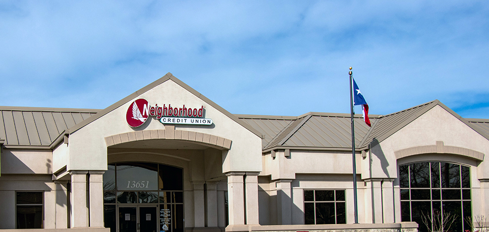 Building with logo sign and flag pole