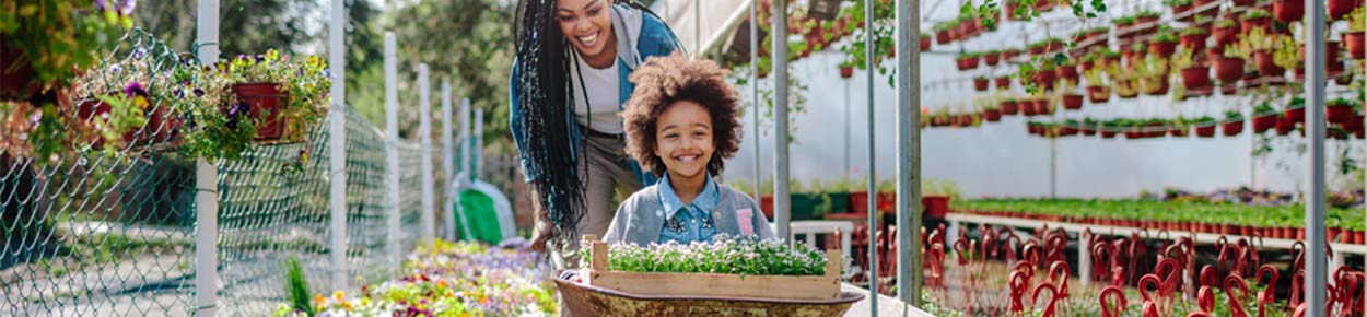 Mother and daughter picking out flowers in a flower nursery