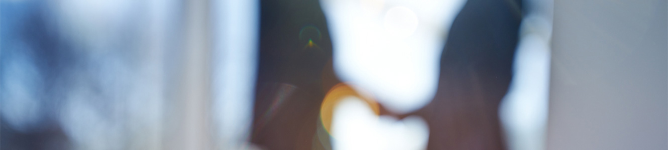blurred image of two people shaking hands.