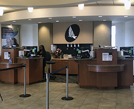 Inside of branch with teller at teller desk