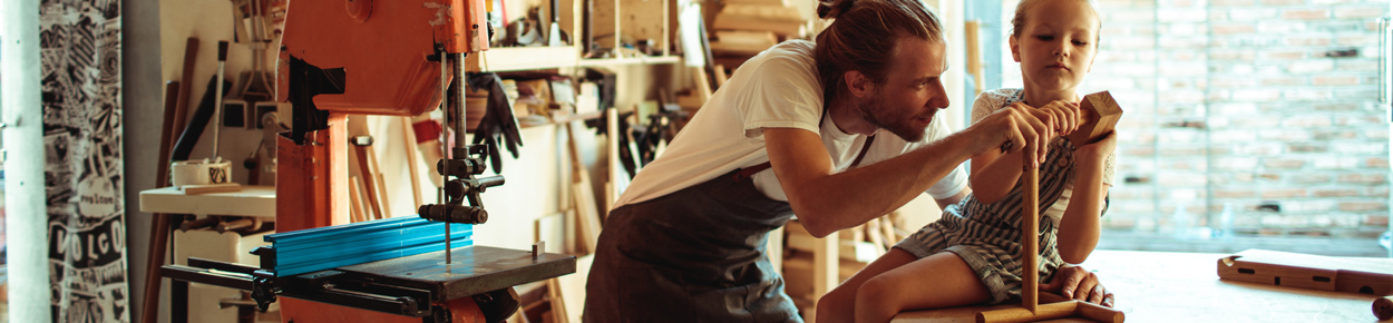 Father and daughter in a woodshop building a project.