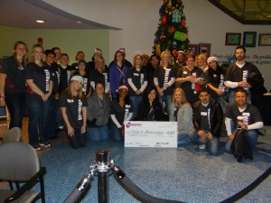 Group of people posing with a large check