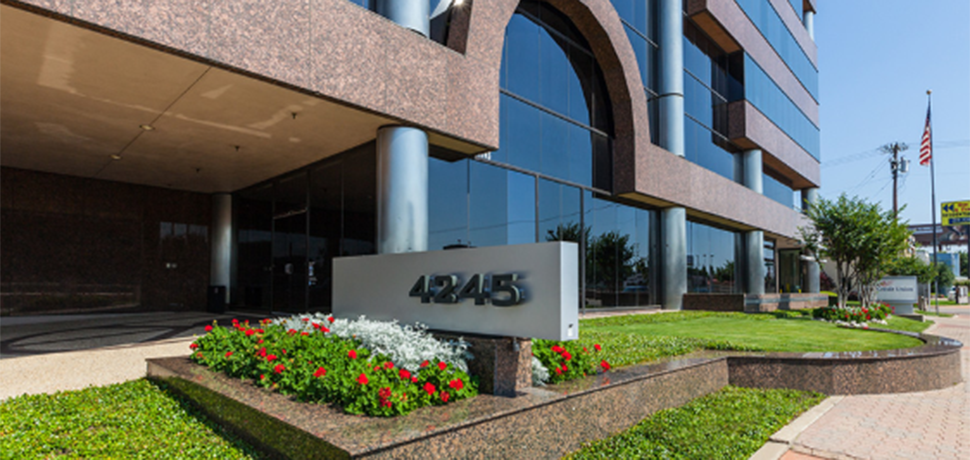 Building with sign and flowers