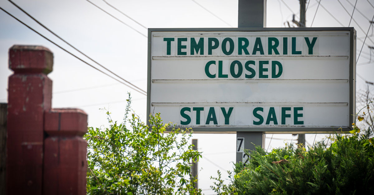 Still image of a business sign that says temporarily closed