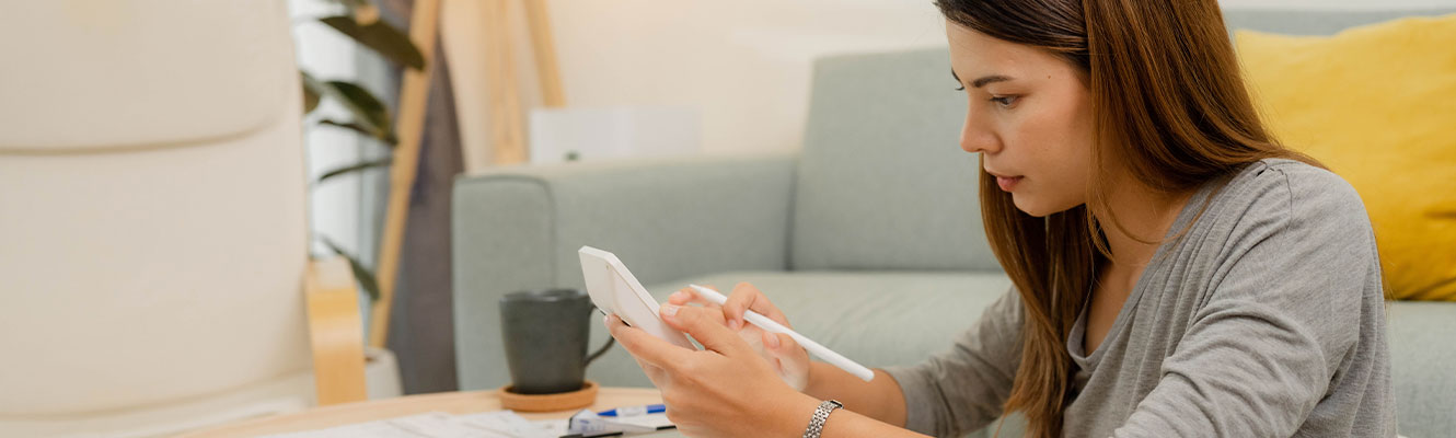 Young women counting college savings fund, tuition fee for student loan with calculator.