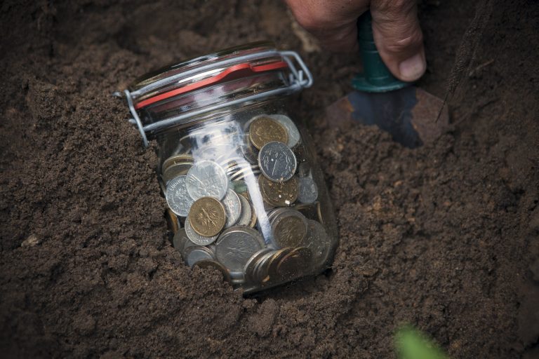 Jar of change in the dirt