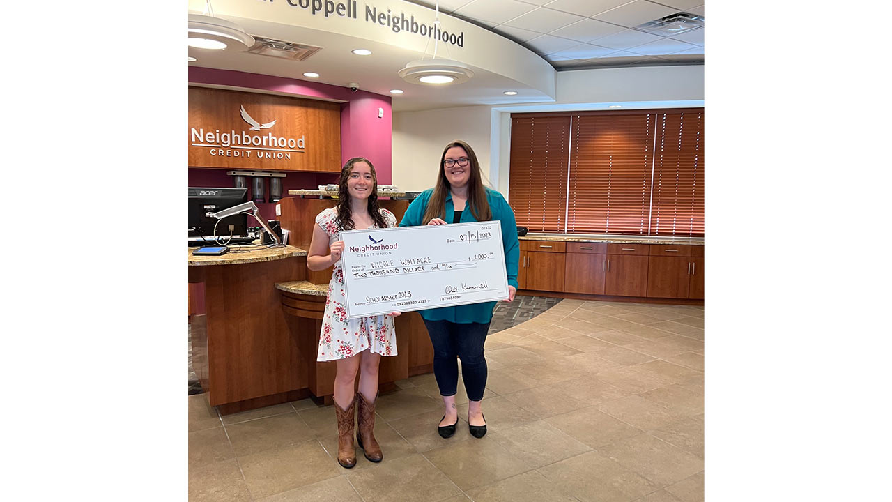 two people holding up the 2023 scholarship oversized check. 