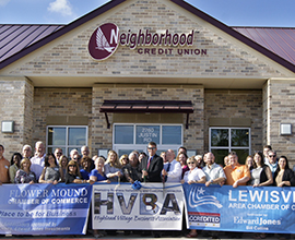 People standing in front of building ribbon cutting