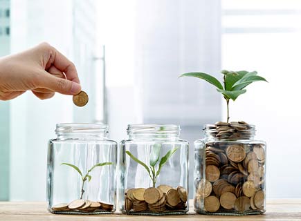 image of a person putting coins in various jars with various amounts. 