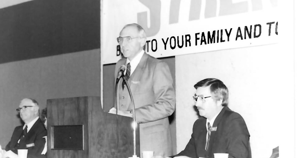 Black and White image of former CEO and President, Calvin Phillips, speaking at a Dallas Postal Credit Union annual meeting