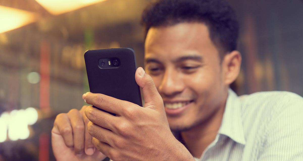 close up adult man holding smartphone and touching on screen device