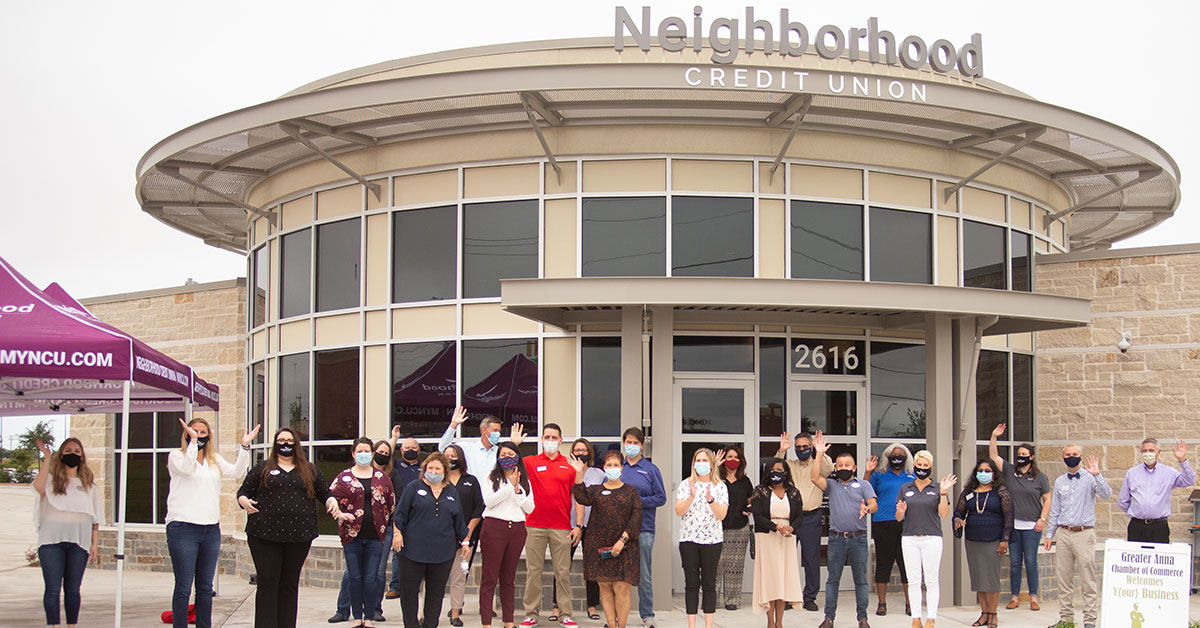 Still shot of Neighborhood Credit Union employees and Anna Chamber of Commerce members celebrating Anna branch grand opening.