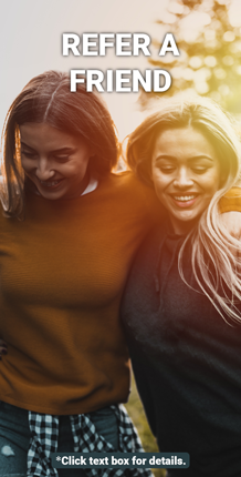 two women outside smiling with arms around each other