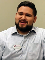 Man in a button down shirt smiling