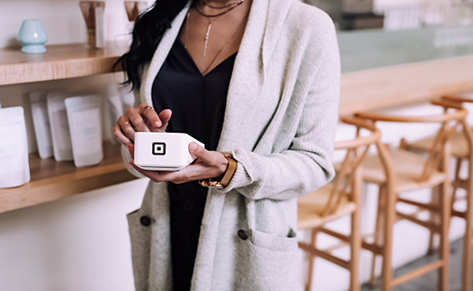 woman holding Square terminal