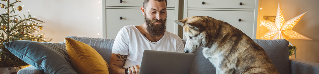 man on the computer with his dog