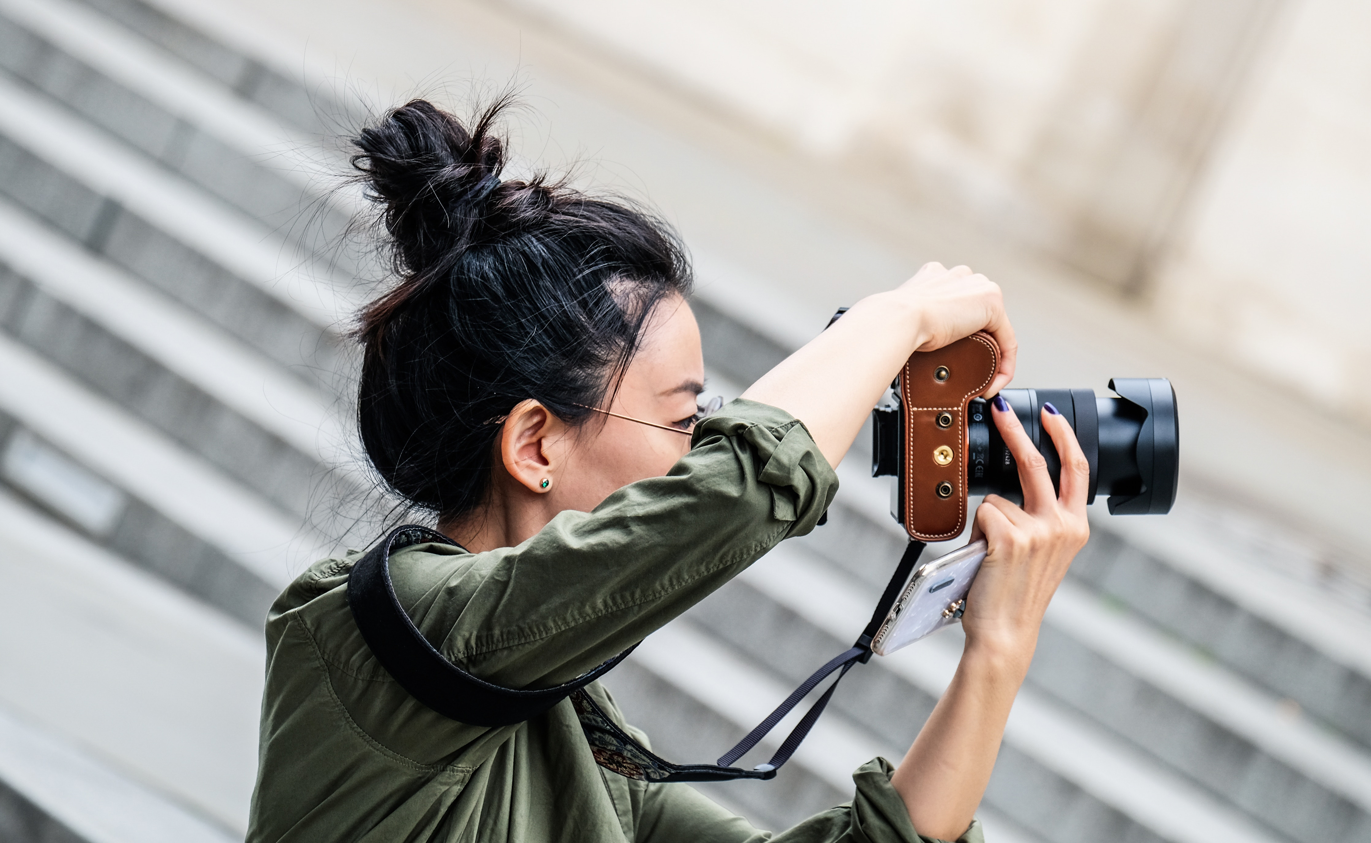 Woman outside with a camera taking photos