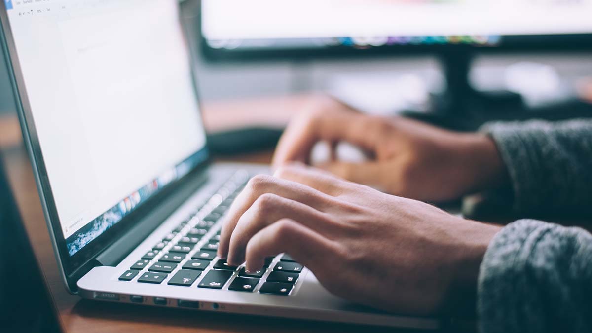 Man typing on apple laptop