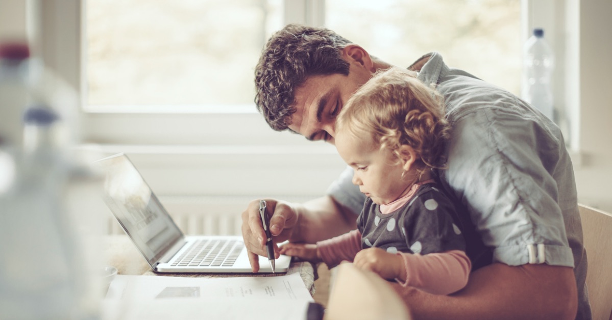 Father is showing his daughter things on a laptop