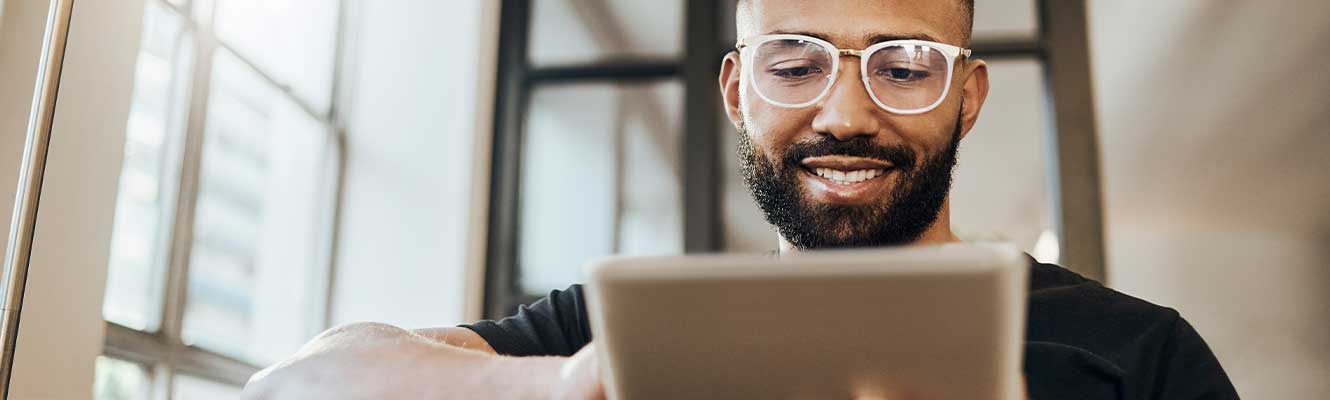 man smiling down at iPad 